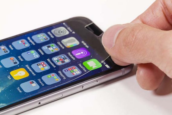 Applying screen protector on mobile phone