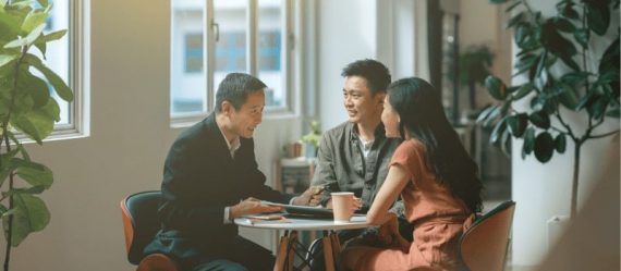 Asian couple discussing with property agent on their first home purchase Asian couple discussing with property agent on their first home purchase