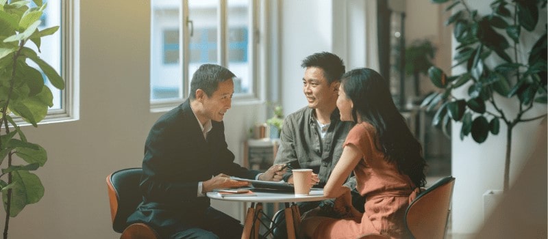 Asian couple discussing with property agent on their first home purchase Asian couple discussing with property agent on their first home purchase
