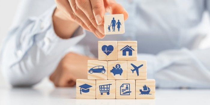 Close-up of hand stacking wooden blocks, symbolising the flexibility and customisation of Choice Protect360