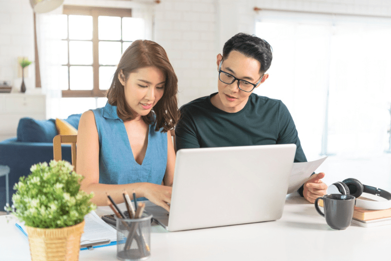 Asian couple browsing for maid insurance plan