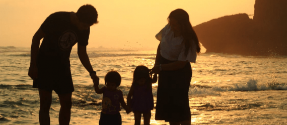 Family at the beach during sunset