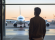 Man looking at planes in airport