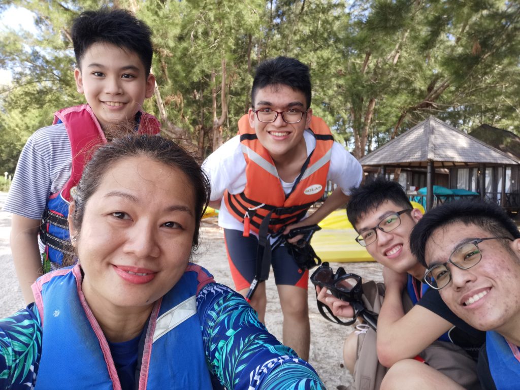 a picture of a family vests smiling in front of the camera, as they excitedly prepare for the water sport activity